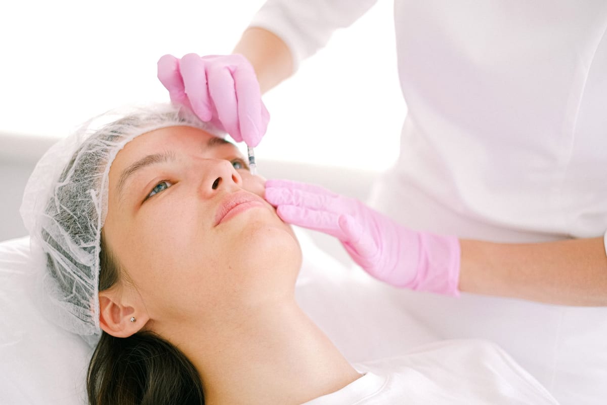 A gloved clinician giving a Botox injection